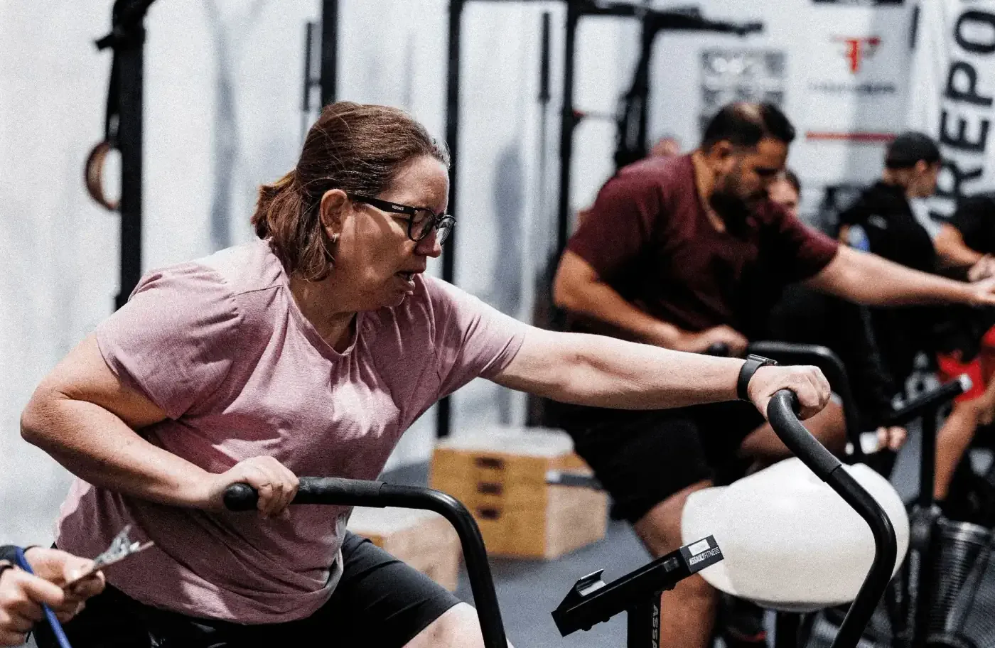 FirePower members on air bikes during a conditioning class