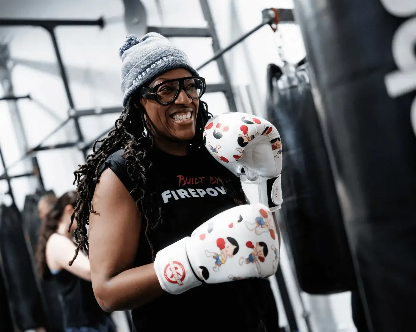 A FirePower boxing coach gloved up and smiling