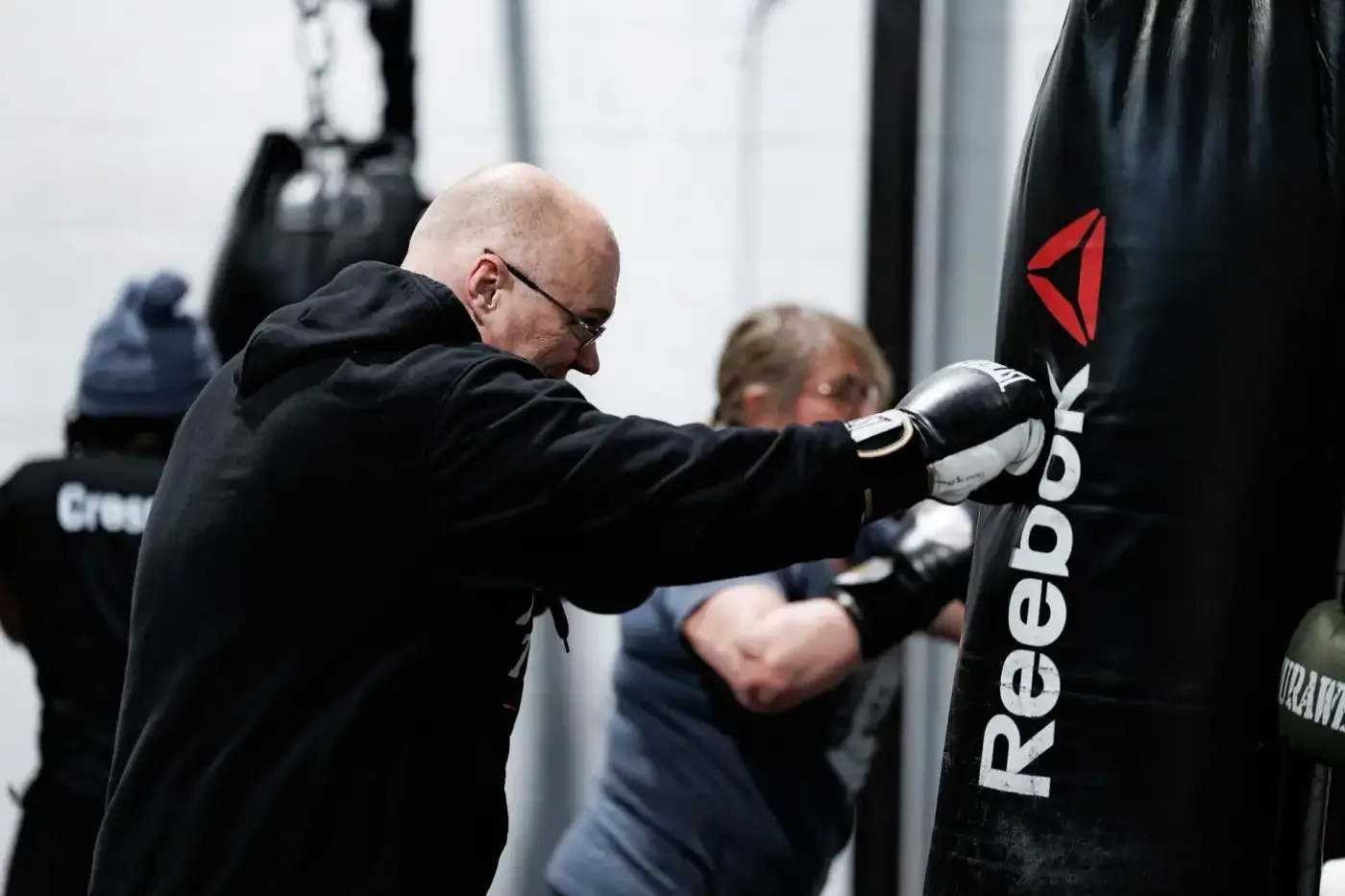 Members working the heavy bags in the FirePower boxing area